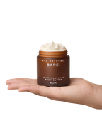 Jar of Bare Almond & Vanilla Body Butter held in a hand on a white background