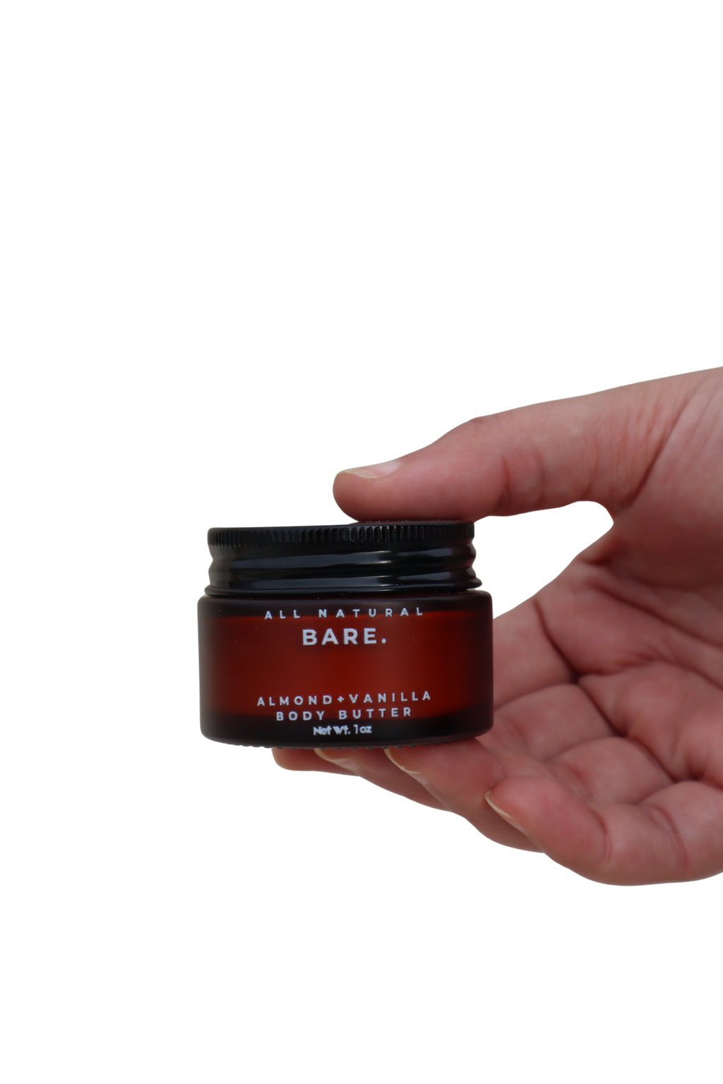 Almond & Vanilla body butter in a frosted amber 30ml glass jar held in a hand against a clean white background, rich tallow moisturizer for dry and very dry sensitive skin by Bare Naturals.