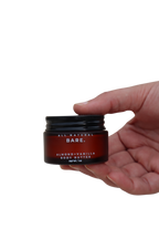 Almond & Vanilla body butter in a frosted amber 30ml glass jar held in a hand against a clean white background, rich tallow moisturizer for dry and very dry sensitive skin by Bare Naturals.