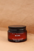Jar of Bare All Natural Frankincense Face Creme on a wooden surface