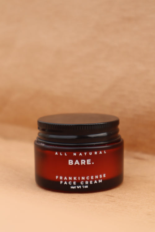 Jar of Bare All Natural Frankincense Face Creme on a wooden surface