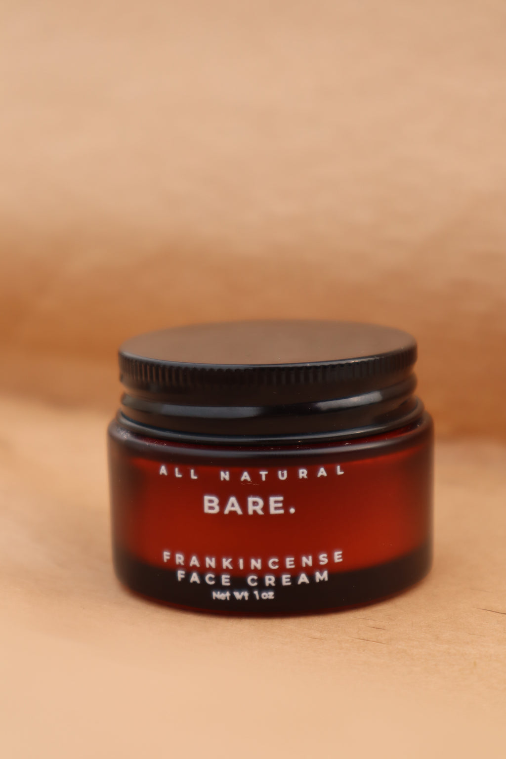 Jar of Bare All Natural Frankincense Face Cream on beige background