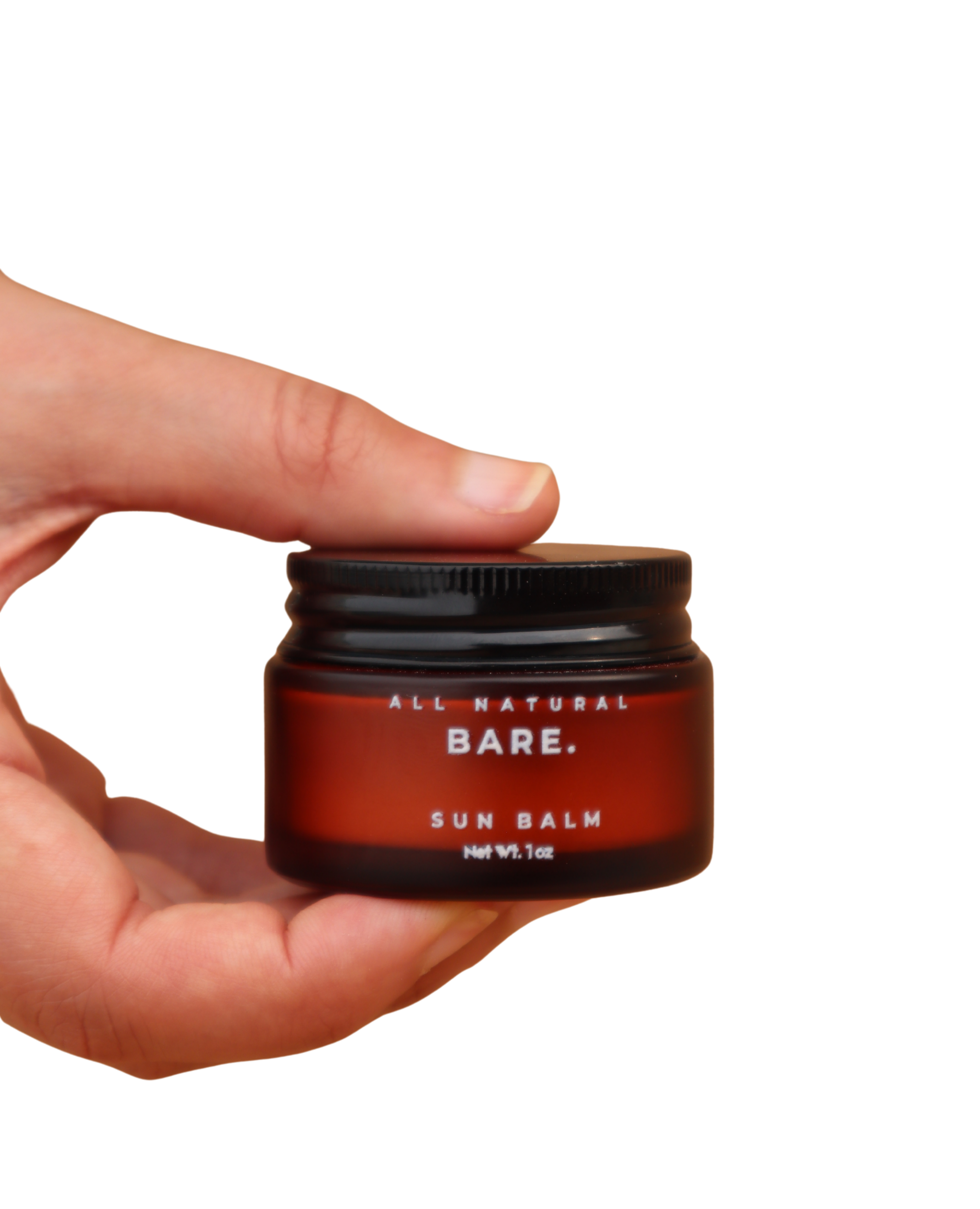 Hand holding a red and black container of Bare All Natural Sun Balm on a white background